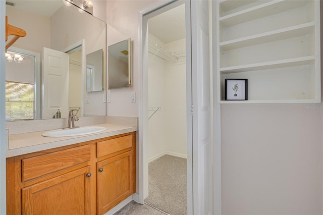 11078 Heathrow Ave, Spring Hill, FL 34609 - bathroom featuring vanity and a walk in closet