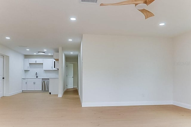 7620 N 74th St, Pinellas Park, FL 33781 - unfurnished living room with light wood finished floors, baseboards, a sink, and recessed lighting