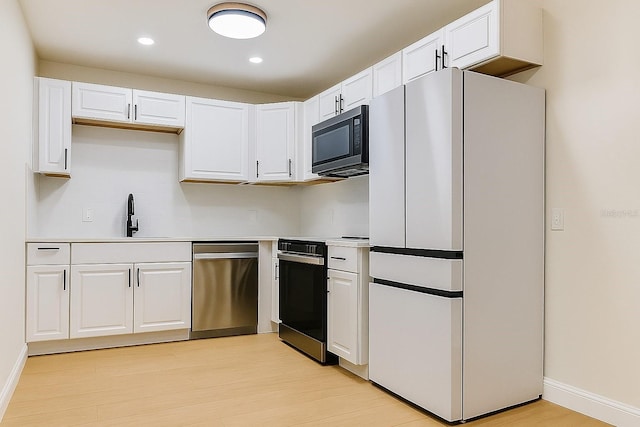 7620 N 74th St, Pinellas Park, FL 33781 - kitchen featuring freestanding refrigerator, dishwasher, black electric range oven, a sink, and white cabinets