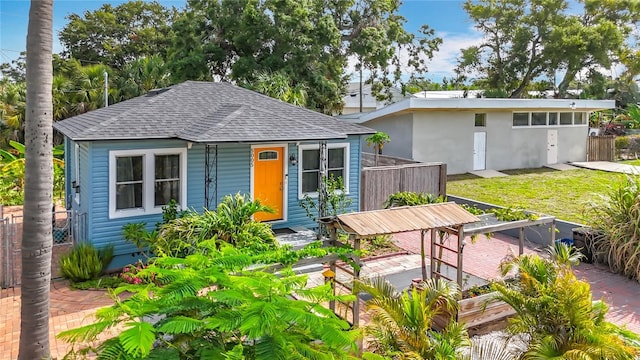 5005 Tangerine Ave S, Gulfport, FL 33707 - view of front facade featuring roof with shingles and an outbuilding