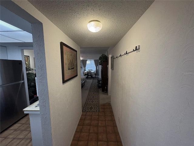 4137 Lake Bayshore Dr Unit C505, Bradenton, FL 34205 - hallway featuring a textured ceiling, a textured wall, and tile patterned floors