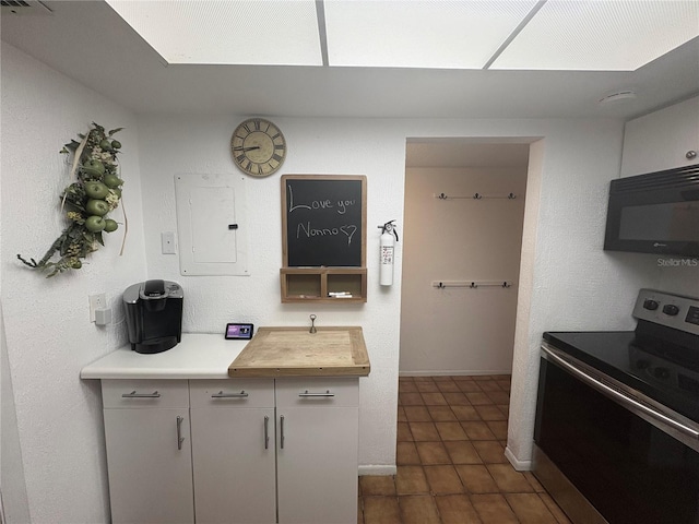 4137 Lake Bayshore Dr Unit C505, Bradenton, FL 34205 - kitchen featuring electric range, black microwave, and electric panel