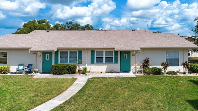 1906 Canterbury Ln Unit 20, Sun City Center, FL 33573 - ranch-style house with a front lawn, stucco siding, and roof with shingles