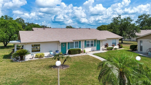 1906 Canterbury Ln Unit 20, Sun City Center, FL 33573 - ranch-style house featuring a front lawn and stucco siding