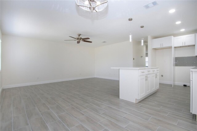 1906 Canterbury Ln Unit 20, Sun City Center, FL 33573 - kitchen with white cabinetry, ceiling fan, baseboards, and recessed lighting