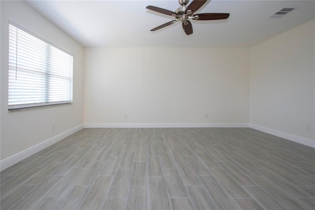 1906 Canterbury Ln Unit 20, Sun City Center, FL 33573 - spare room with ceiling fan, light wood-style flooring, and baseboards