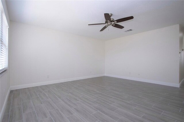 1906 Canterbury Ln Unit 20, Sun City Center, FL 33573 - spare room with a ceiling fan, wood finished floors, and baseboards