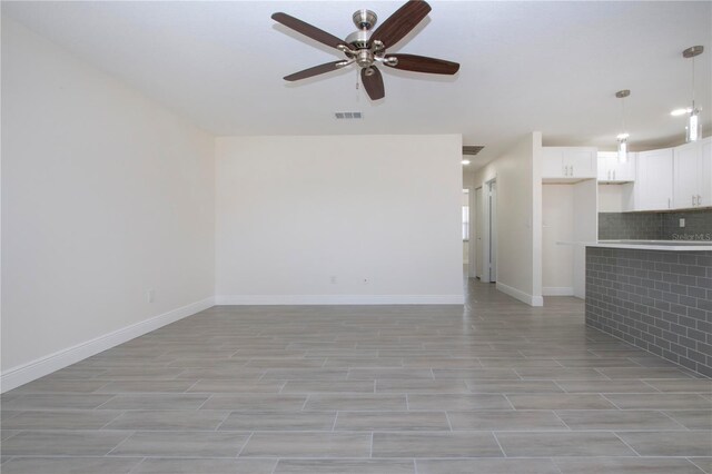 1906 Canterbury Ln Unit 20, Sun City Center, FL 33573 - unfurnished living room with a ceiling fan, baseboards, and light wood-style flooring