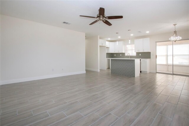 1906 Canterbury Ln Unit 20, Sun City Center, FL 33573 - unfurnished living room featuring ceiling fan, baseboards, recessed lighting, light wood-style floors, and a sink