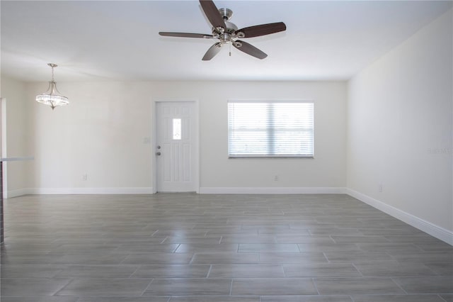 1906 Canterbury Ln Unit 20, Sun City Center, FL 33573 - foyer featuring a ceiling fan, wood finished floors, a chandelier, and baseboards