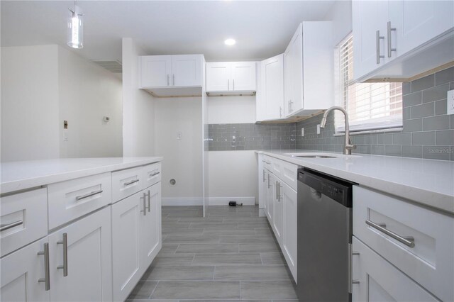 1906 Canterbury Ln Unit 20, Sun City Center, FL 33573 - kitchen with stainless steel dishwasher, a sink, white cabinetry, light countertops, and recessed lighting