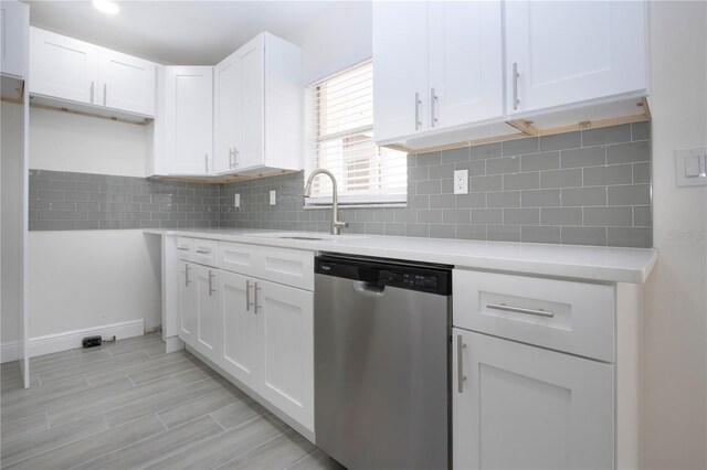 1906 Canterbury Ln Unit 20, Sun City Center, FL 33573 - kitchen with dishwasher, a sink, white cabinets, light countertops, and backsplash