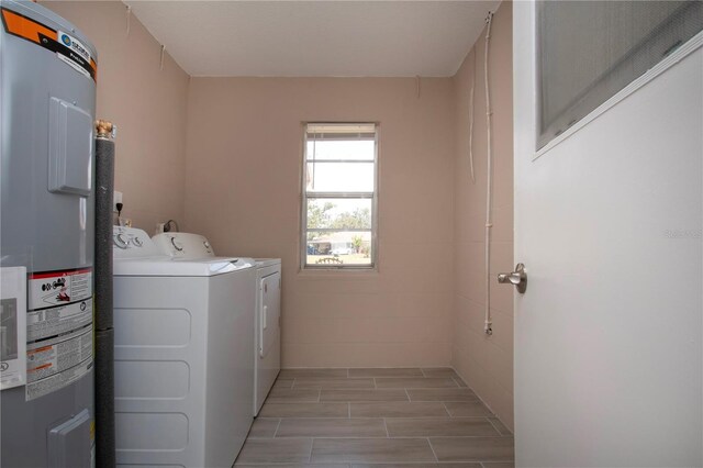 1906 Canterbury Ln Unit 20, Sun City Center, FL 33573 - laundry room featuring water heater, washer and clothes dryer, and wood finish floors