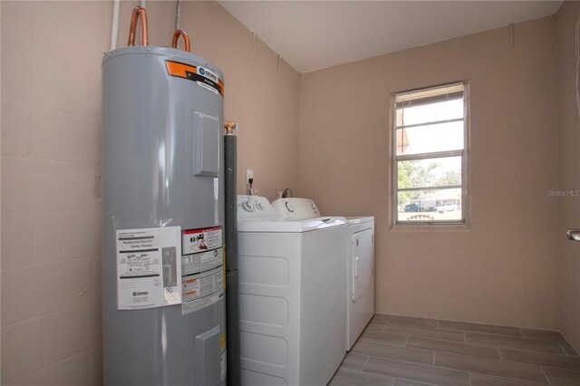 1906 Canterbury Ln Unit 20, Sun City Center, FL 33573 - washroom with water heater, washer and clothes dryer, and wood tiled floors