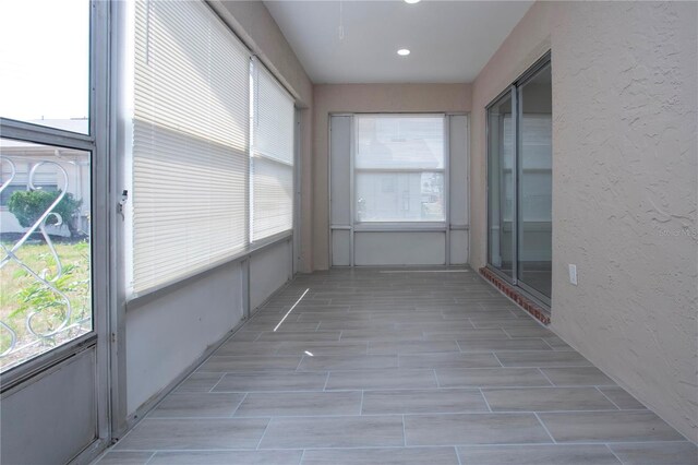 1906 Canterbury Ln Unit 20, Sun City Center, FL 33573 - unfurnished sunroom with wood finish floors, recessed lighting, and a textured wall