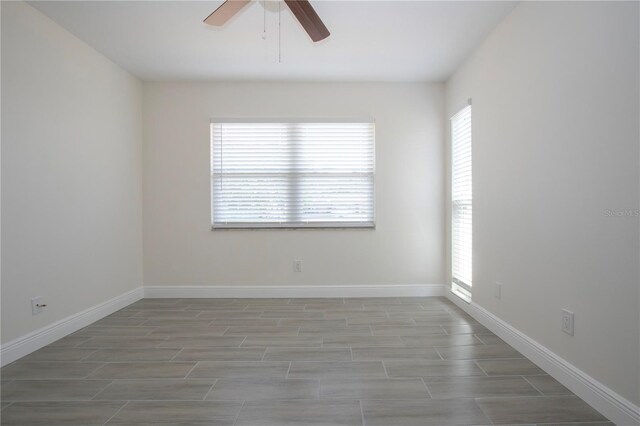 1906 Canterbury Ln Unit 20, Sun City Center, FL 33573 - empty room featuring healthy amount of natural light, a ceiling fan, baseboards, and wood finish floors