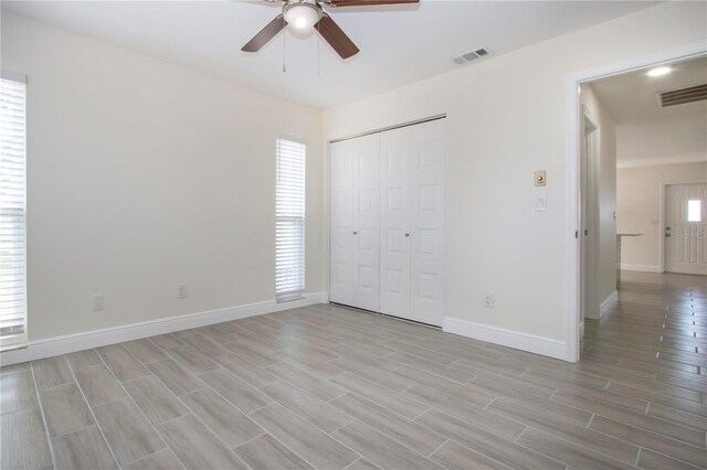 1906 Canterbury Ln Unit 20, Sun City Center, FL 33573 - unfurnished bedroom with baseboards, light wood-type flooring, a closet, and ceiling fan