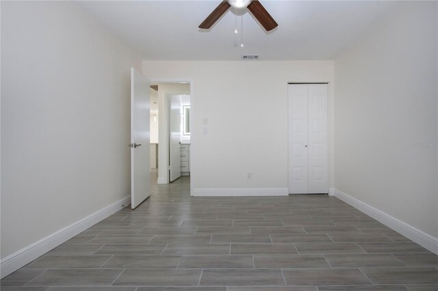 1906 Canterbury Ln Unit 20, Sun City Center, FL 33573 - unfurnished bedroom featuring baseboards, wood finished floors, a closet, and ceiling fan