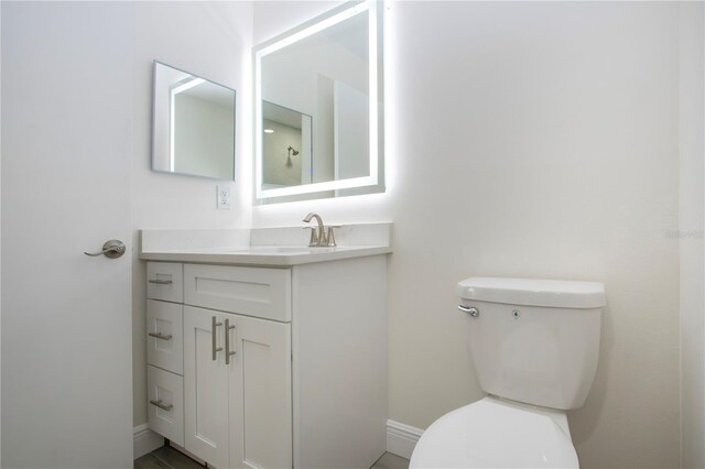 1906 Canterbury Ln Unit 20, Sun City Center, FL 33573 - bathroom with toilet, vanity, and baseboards