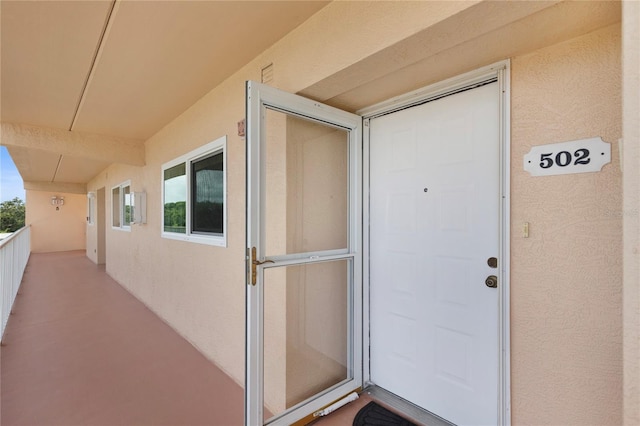 9461 Harbor Greens Way Unit 502, Seminole, FL 33776 - entrance to property featuring stucco siding and a balcony
