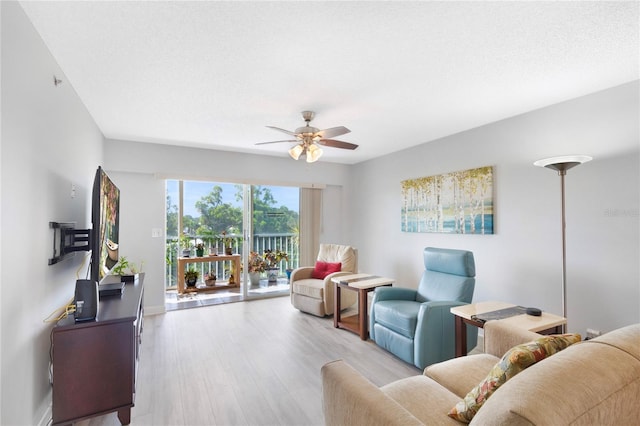 9461 Harbor Greens Way Unit 502, Seminole, FL 33776 - living room featuring wood finished floors, a ceiling fan, and baseboards
