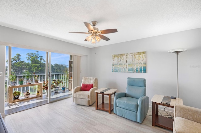 9461 Harbor Greens Way Unit 502, Seminole, FL 33776 - sitting room with ceiling fan, light wood-style floors, and a textured ceiling