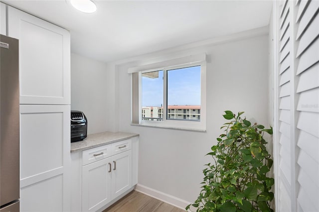 9461 Harbor Greens Way Unit 502, Seminole, FL 33776 - interior space featuring light wood finished floors, baseboards, and freestanding refrigerator