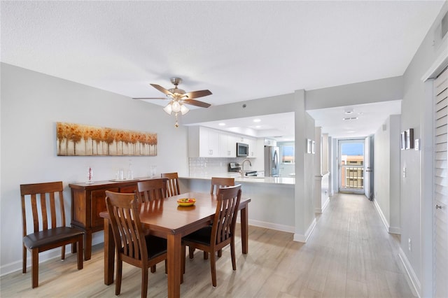 9461 Harbor Greens Way Unit 502, Seminole, FL 33776 - dining space featuring light wood-type flooring, baseboards, and a ceiling fan
