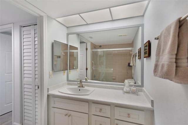 9461 Harbor Greens Way Unit 502, Seminole, FL 33776 - bathroom with a closet, vanity, and a shower with shower door