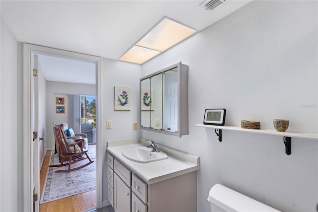 9461 Harbor Greens Way Unit 502, Seminole, FL 33776 - bathroom with toilet, vanity, and wood finished floors