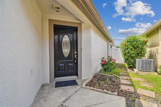 19409 Weymouth Dr, Land O Lakes, FL 34638 - entrance to property featuring stucco siding and central AC unit