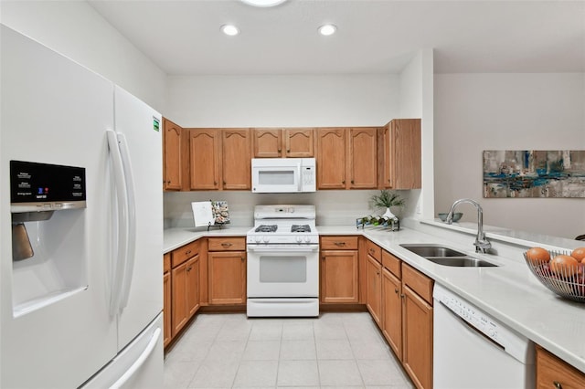 19409 Weymouth Dr, Land O Lakes, FL 34638 - kitchen featuring white appliances, a sink, light countertops, light tile patterned floors, and brown cabinetry