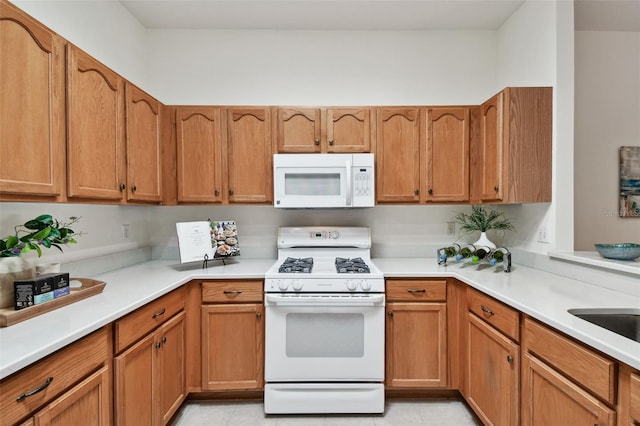 19409 Weymouth Dr, Land O Lakes, FL 34638 - kitchen with white appliances, light countertops, and brown cabinets
