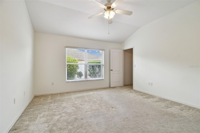 19409 Weymouth Dr, Land O Lakes, FL 34638 - spare room with vaulted ceiling, light colored carpet, baseboards, and ceiling fan