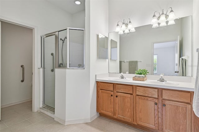19409 Weymouth Dr, Land O Lakes, FL 34638 - bathroom with a stall shower, double vanity, tile patterned flooring, a chandelier, and baseboards
