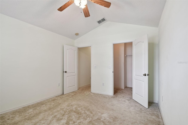 19409 Weymouth Dr, Land O Lakes, FL 34638 - unfurnished bedroom featuring vaulted ceiling, light carpet, a walk in closet, ceiling fan, and baseboards