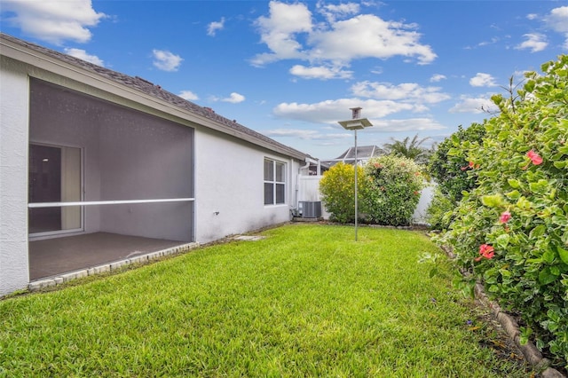 19409 Weymouth Dr, Land O Lakes, FL 34638 - view of yard with central air condition unit and a patio area