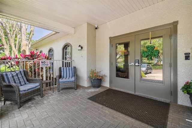 19409 Weymouth Dr, Land O Lakes, FL 34638 - property entrance with stucco siding and french doors