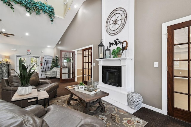 19409 Weymouth Dr, Land O Lakes, FL 34638 - carpeted living area with high vaulted ceiling, a ceiling fan, baseboards, a glass covered fireplace, and recessed lighting