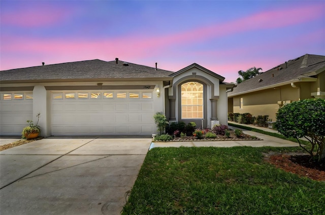 19409 Weymouth Dr, Land O Lakes, FL 34638 - ranch-style house featuring a garage, driveway, and stucco siding