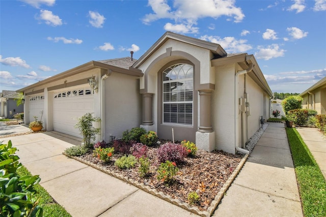 19409 Weymouth Dr, Land O Lakes, FL 34638 - view of front facade featuring stucco siding, an attached garage, and concrete driveway