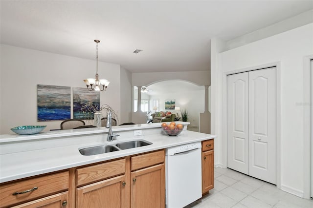 19409 Weymouth Dr, Land O Lakes, FL 34638 - kitchen featuring dishwasher, a sink, arched walkways, light countertops, and light tile patterned floors