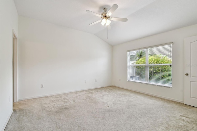19409 Weymouth Dr, Land O Lakes, FL 34638 - spare room featuring light colored carpet, vaulted ceiling, a ceiling fan, and baseboards