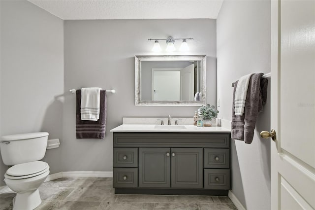 19409 Weymouth Dr, Land O Lakes, FL 34638 - bathroom featuring vanity, baseboards, and toilet