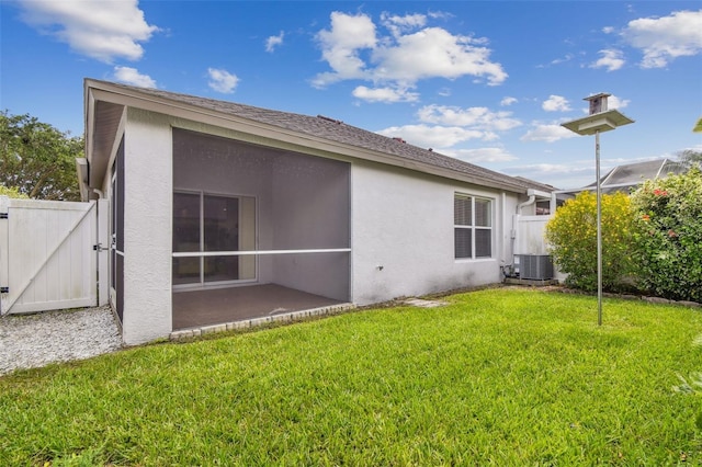 19409 Weymouth Dr, Land O Lakes, FL 34638 - back of house with stucco siding, a gate, central AC, and a patio