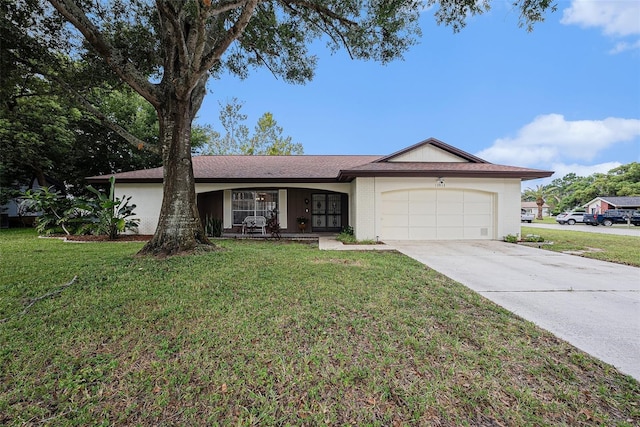 13013 Sawmill Way, Hudson, FL 34667 - single story home with an attached garage, driveway, a front lawn, and covered porch