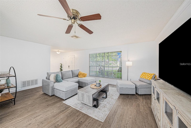 13013 Sawmill Way, Hudson, FL 34667 - living area featuring a textured ceiling, wood finished floors, ceiling fan, and baseboards