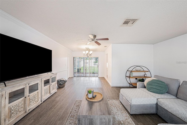 13013 Sawmill Way, Hudson, FL 34667 - living room featuring a textured ceiling, a chandelier, a ceiling fan, wood finished floors, and ornamental molding