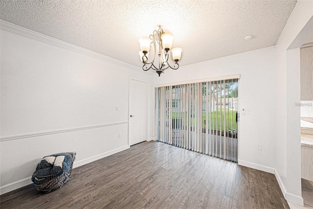 13013 Sawmill Way, Hudson, FL 34667 - unfurnished dining area featuring a chandelier, wood finished floors, a textured ceiling, baseboards, and ornamental molding