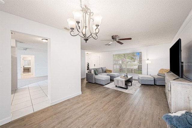 13013 Sawmill Way, Hudson, FL 34667 - living area featuring ceiling fan, a textured ceiling, light wood-type flooring, a chandelier, and baseboards